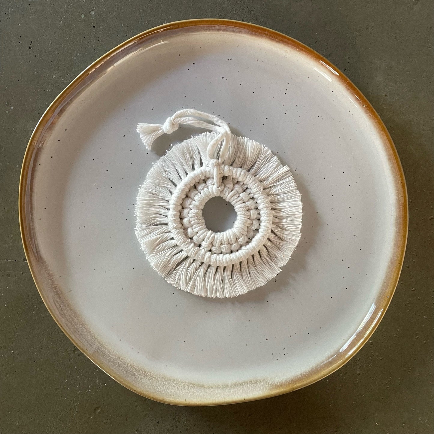 Off-White Wreath Ornament centered on dinner plate
