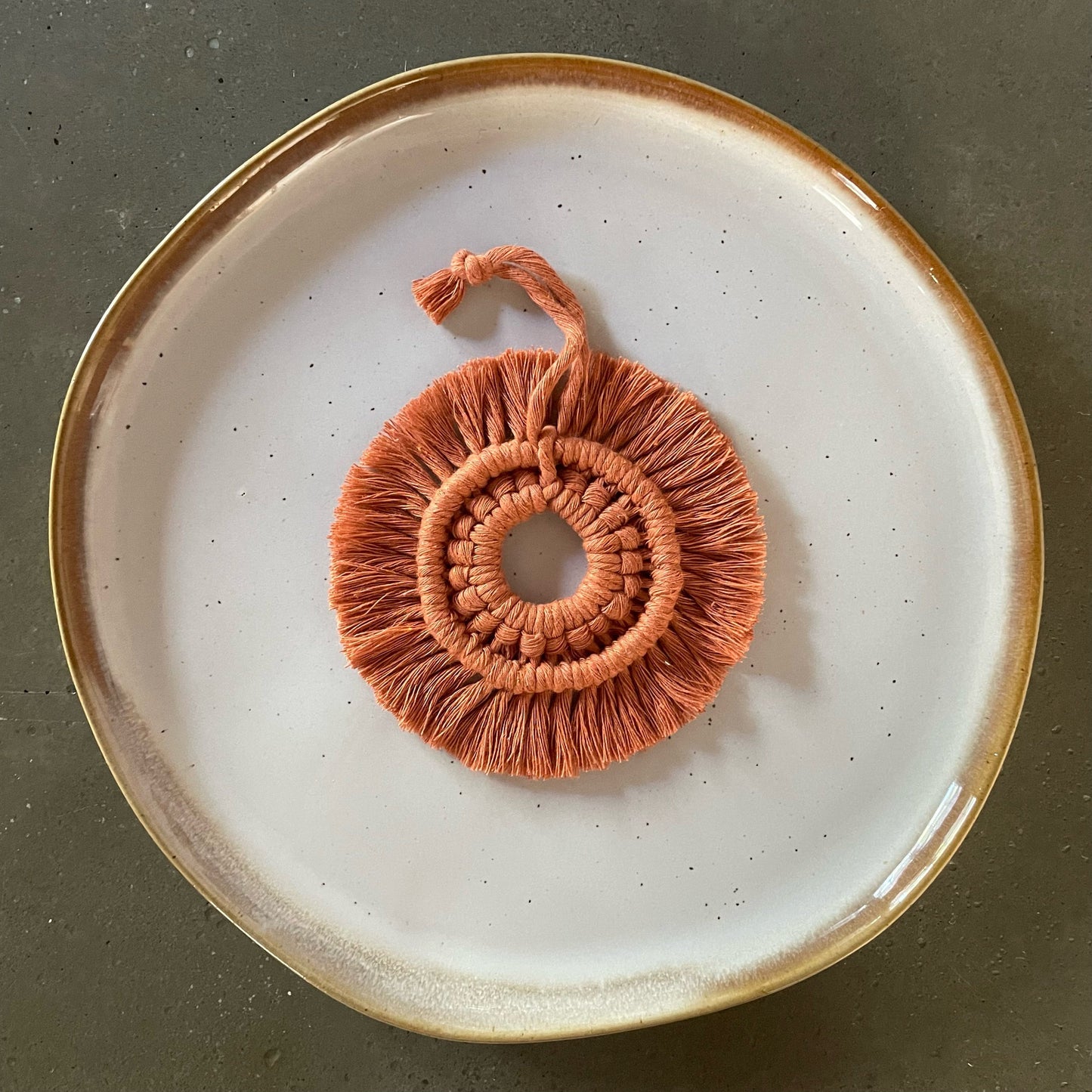 Terracotta Wreath Ornament centered on dinner plate