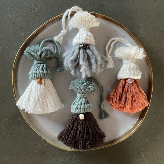 Set of 4 gnomes, grouped on dinner plate. 1) pearl-colored hat, dark coffee nose, silver curly beard; 2) pearl-colored hat, mauve nose, terracotta combed beard; 3) laurel green hat, light coffee nose, off-white combed beard; 4) laurel green hat, beige nose, chocolate wavy beard  