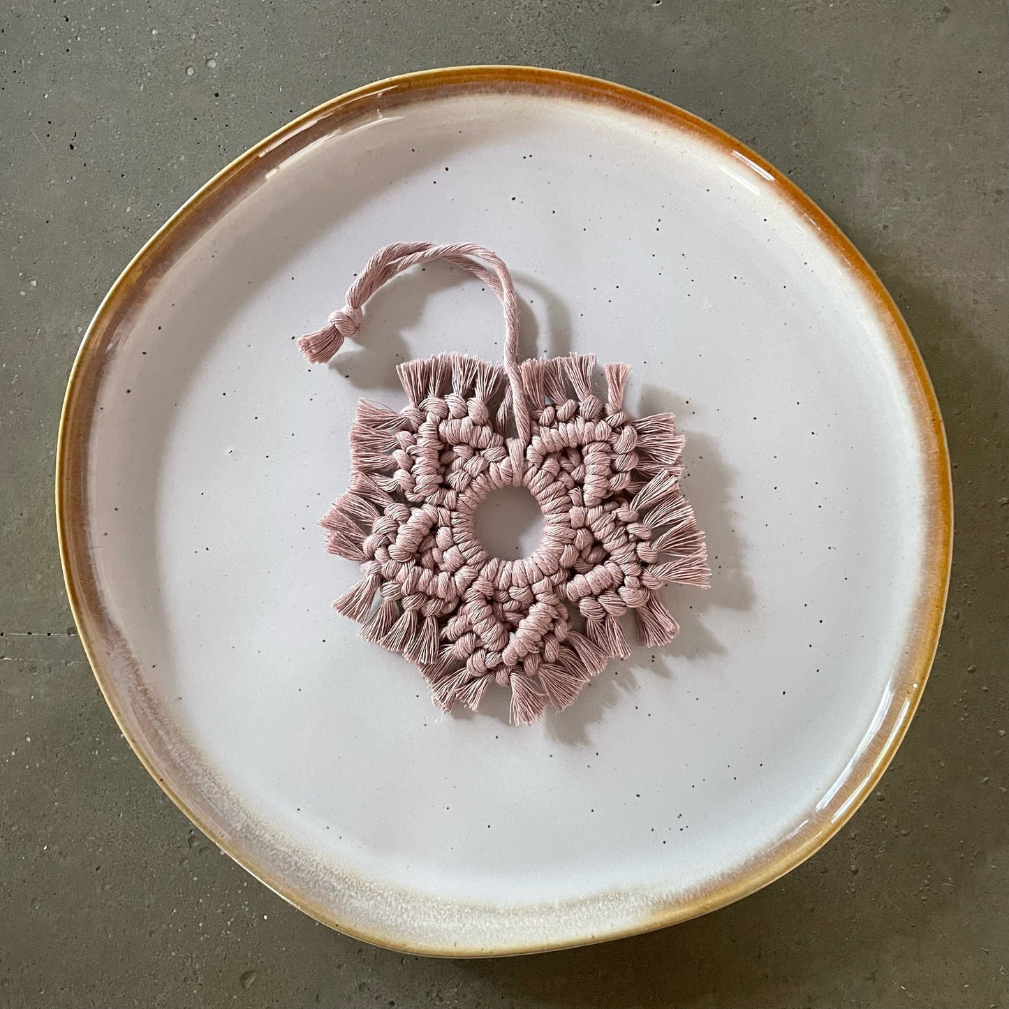 Mauve Snowflake Ornament centered on dinner plate