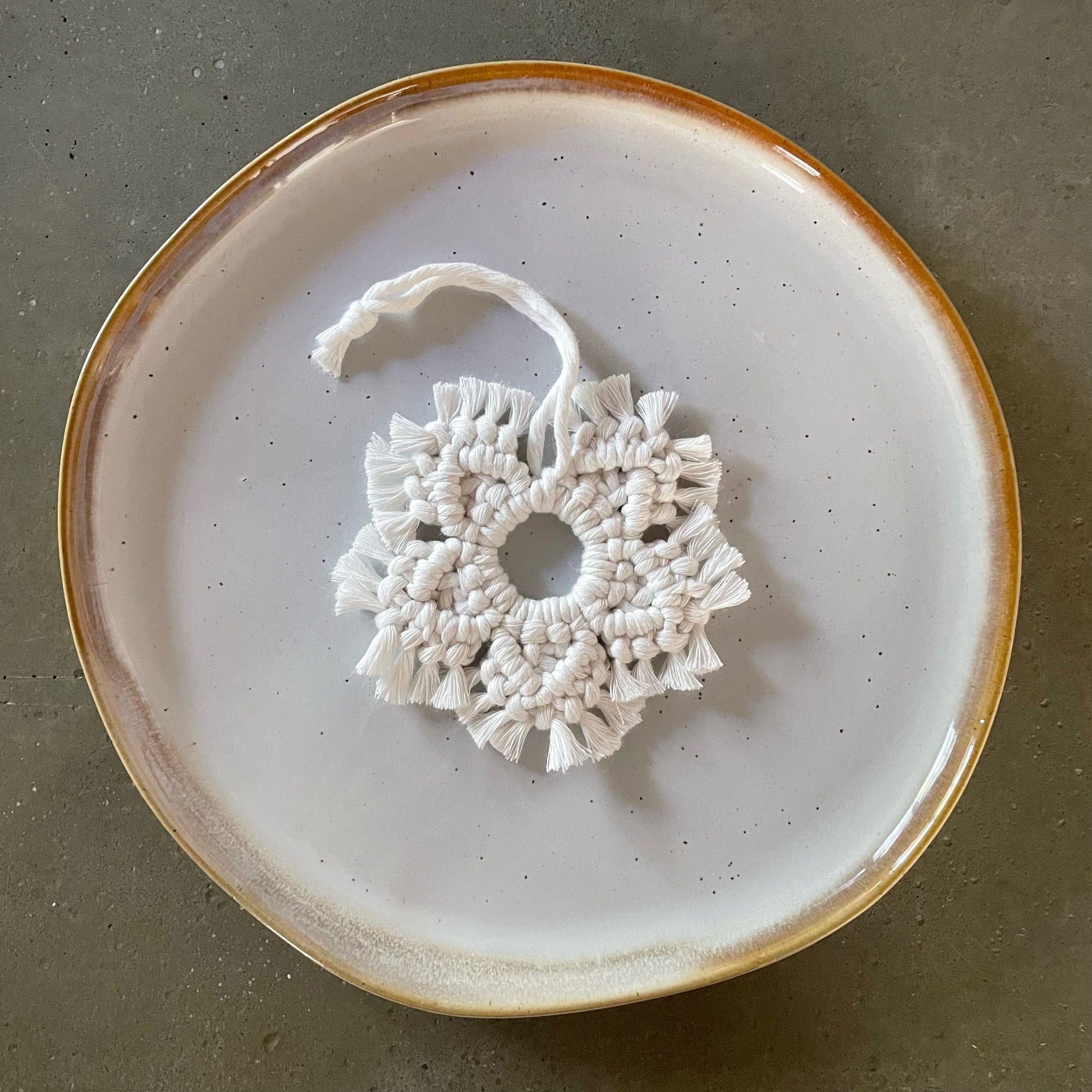 Off-White Snowflake Ornament centered on dinner plate