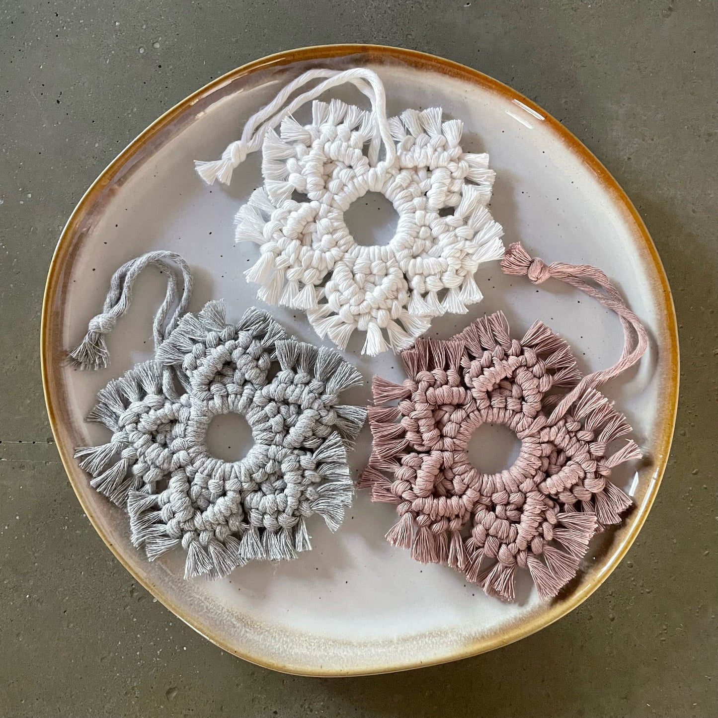 3 Snowflake Ornaments grouped on dinner plate
