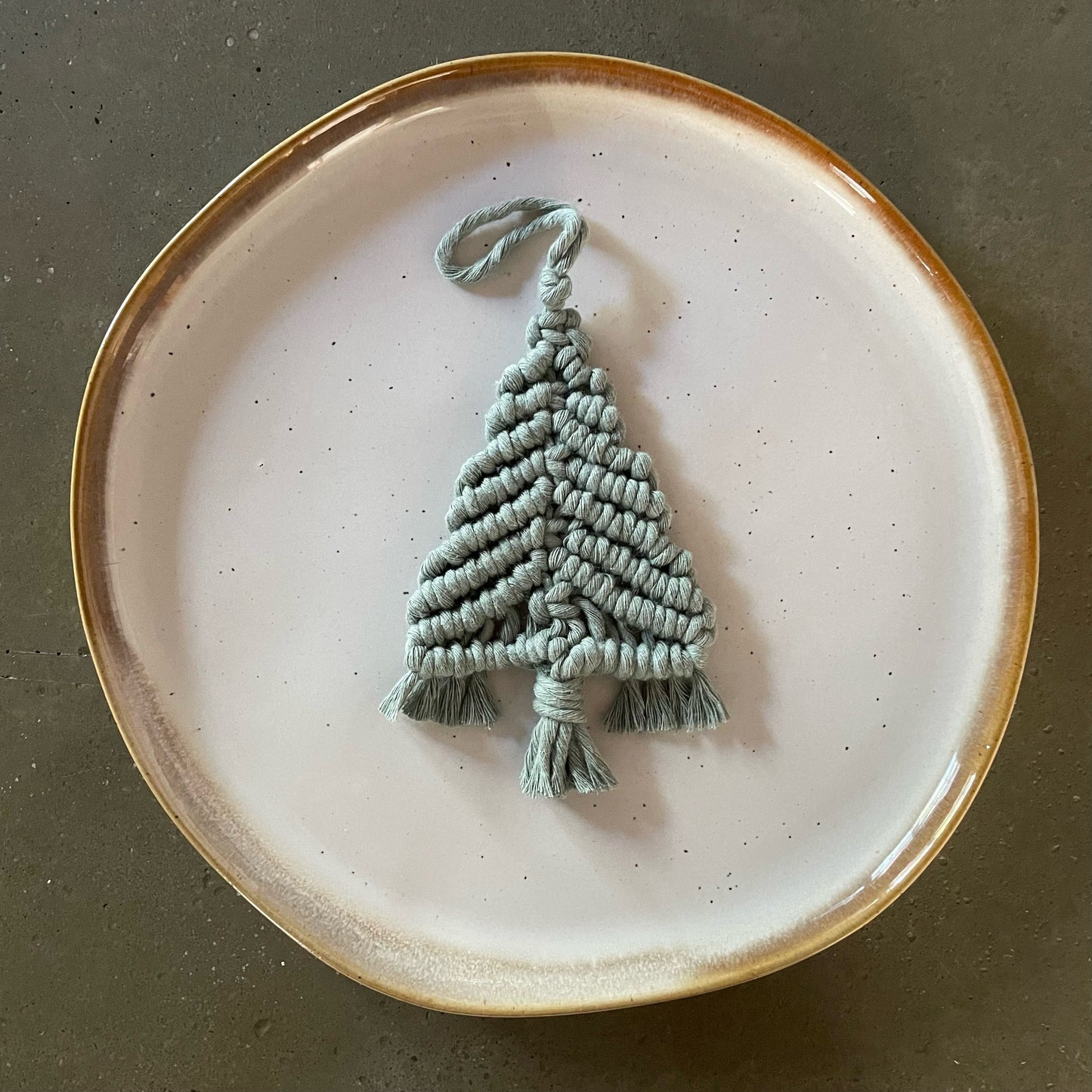 Laurel Green Tree Ornament centered on dinner plate
