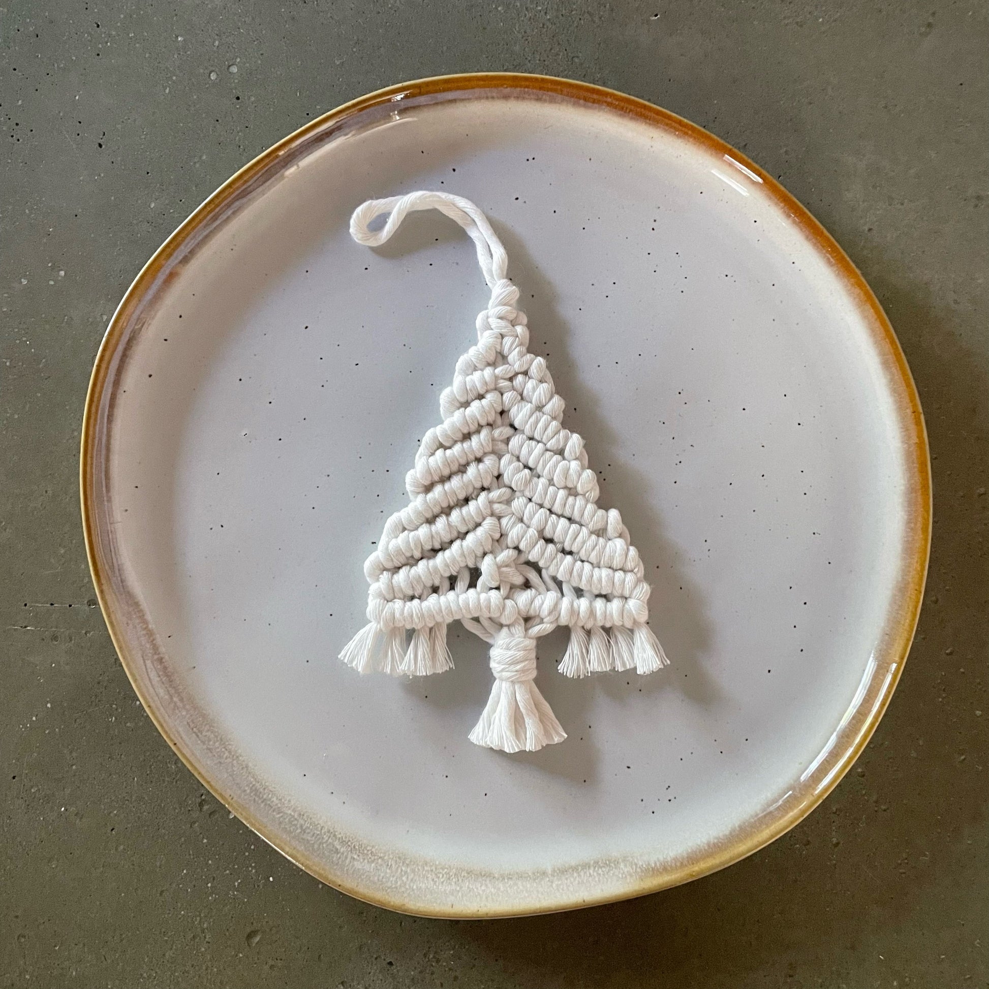 Off-White Tree Ornament centered on dinner plate